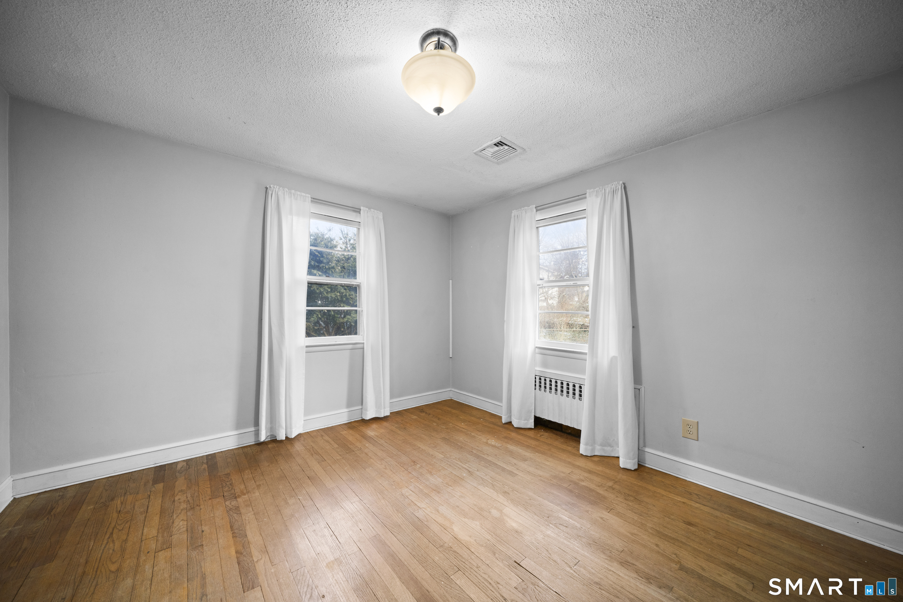 514 Hilliard Street Manchester, CT 06042 - Photo 21 of 38 wooden floor in an empty room with a window