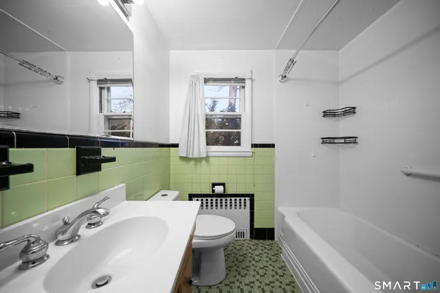 a bathroom with a sink a toilet and bathtub