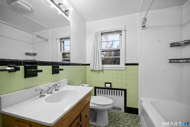 a bathroom with a sink a toilet and bathtub