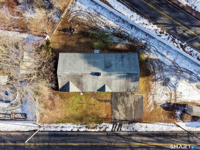 a view of a houses with cars parked