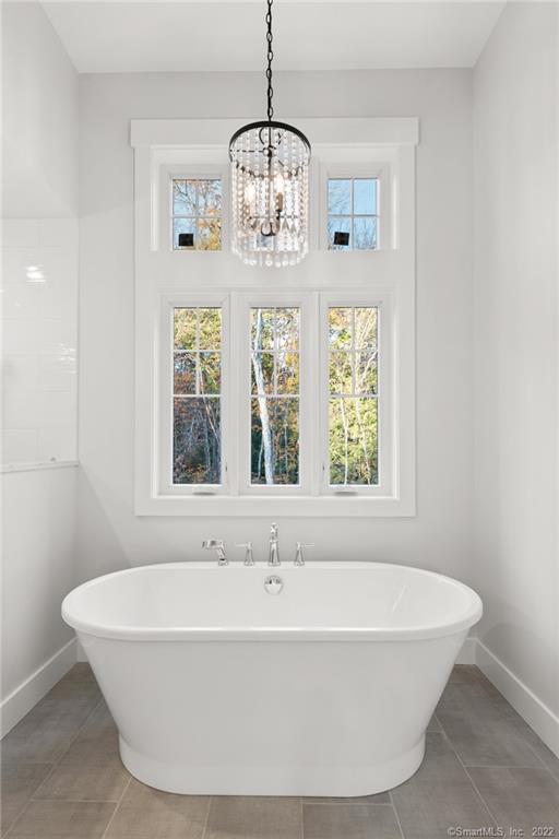 114 Daniel Trace Burlington, CT 06013 - Photo 15 of 30 a white bath tub sitting in a bathroom next to a window