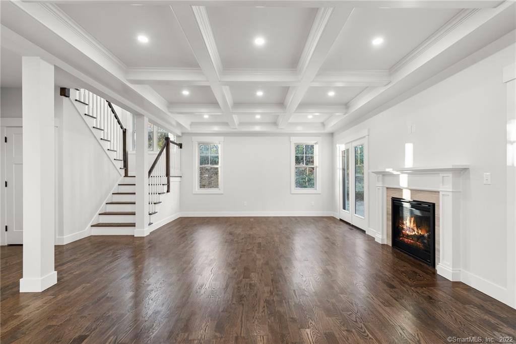 114 Daniel Trace Burlington, CT 06013 - Photo 4 of 30 an empty room with wooden floor fireplace and windows