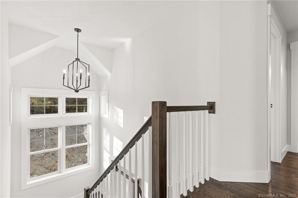 114 Daniel Trace Burlington, CT 06013 - Photo 9 of 30 a view of a hallway with windows and chandelier