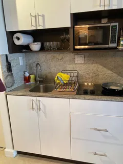 a kitchen with a microwave a stove and cabinets