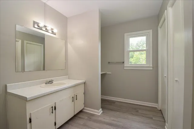 a spacious bathroom with a double vanity sink and a mirror