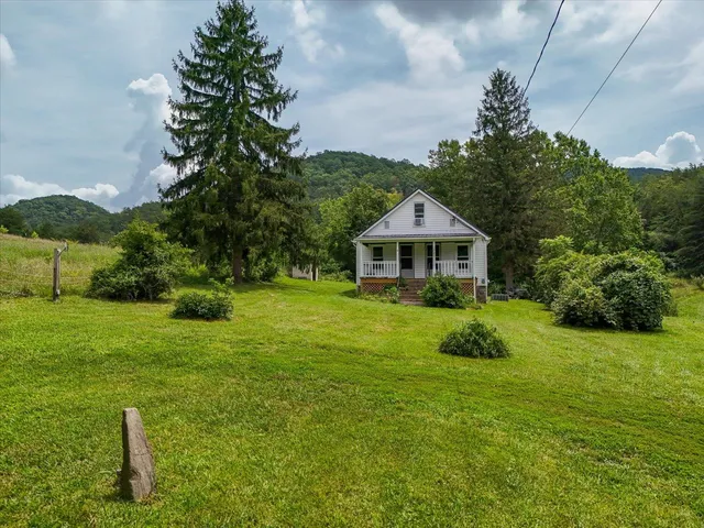 a house with lots of trees in the background