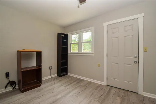 an empty room with closet and wooden floor