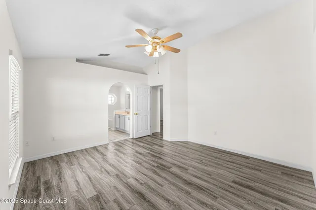a view of empty room with wooden floor