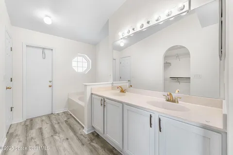 a bathroom with a sink a light fixture and a mirror