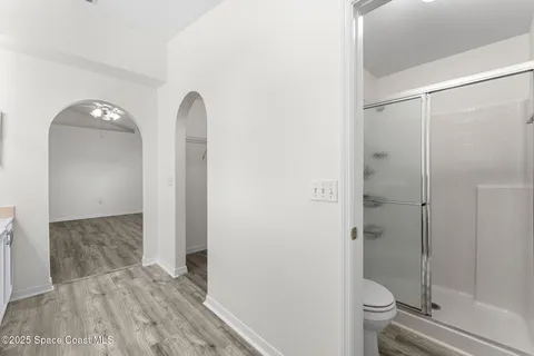 a bathroom with a granite countertop shower a toilet and a sink