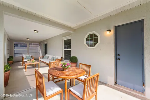 a view of a dining room with furniture and window