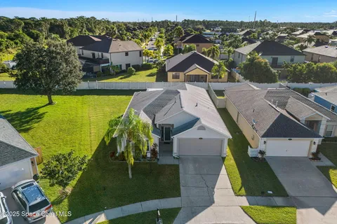 an aerial view of residential houses with outdoor space