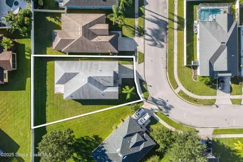 an aerial view of a house with swimming pool