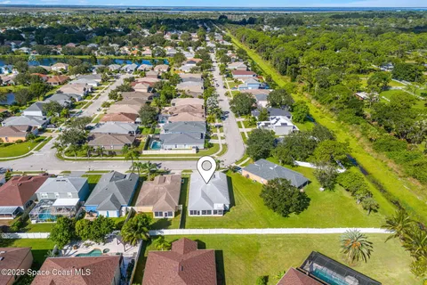 an aerial view of residential houses with outdoor space and swimming pool