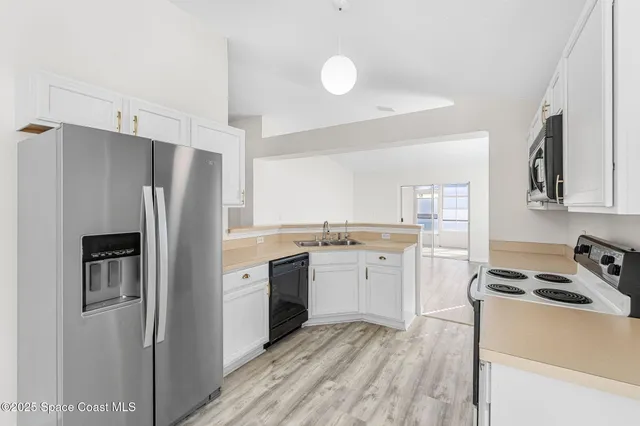 a kitchen with a refrigerator stove and sink