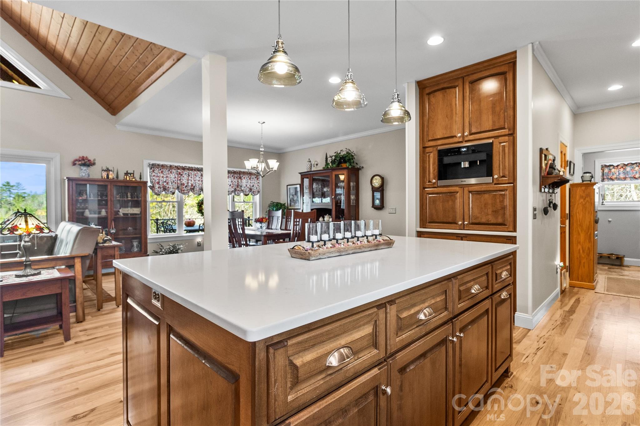 1103 River Ridge Way Lenoir, NC 28645 - Photo 12 of 46 a kitchen with stainless steel appliances kitchen island granite countertop a refrigerator a stove and a sink with wooden floor