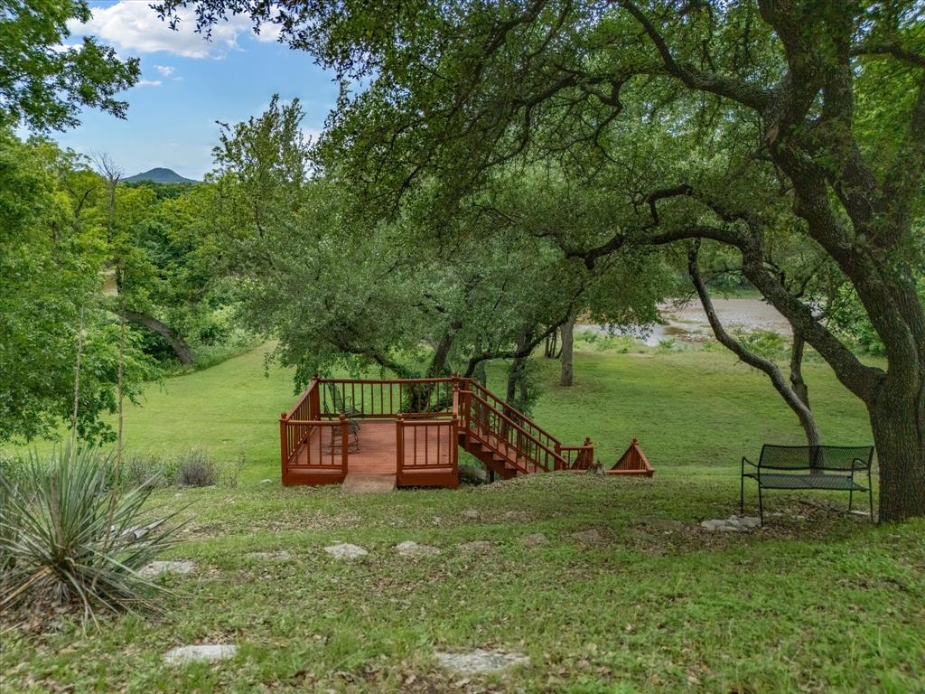 10106 Ravenswood Road Granbury, TX 76049 - Photo 26 of 39 a view of a garden with a bench