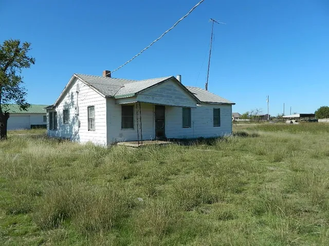 a view of a house with a yard and deck