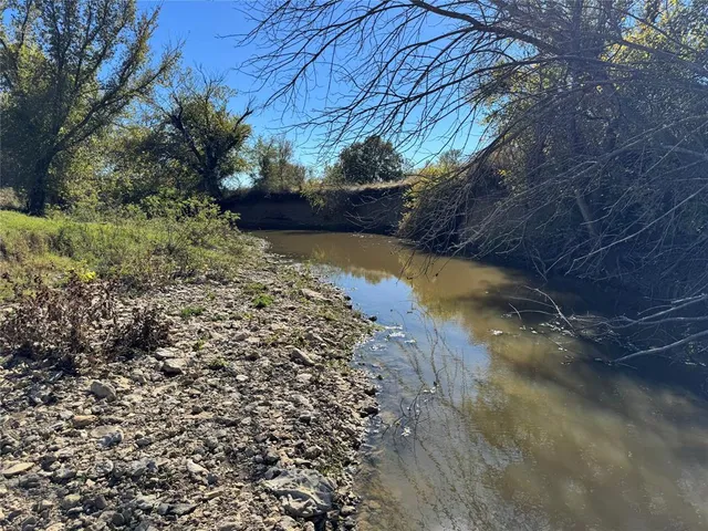 a view of a tennis ground with a trees