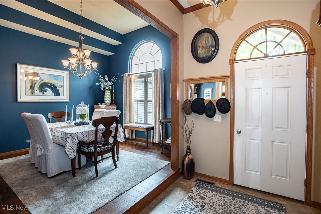 126 Timber Ridge Drive Elyria, OH 44035 - Photo 6 of 49 Dining area with a chandelier, plenty of natural light, baseboards, and beam ceiling