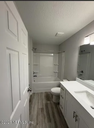 a kitchen with cabinets and wooden floor