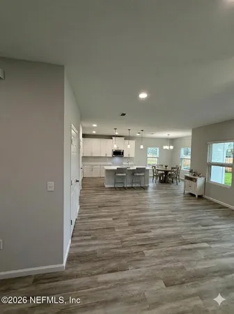 a view of a kitchen with kitchen island a sink stainless steel appliances and cabinets