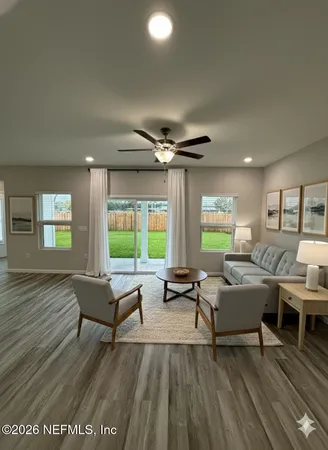 a living room with furniture and a wooden floor