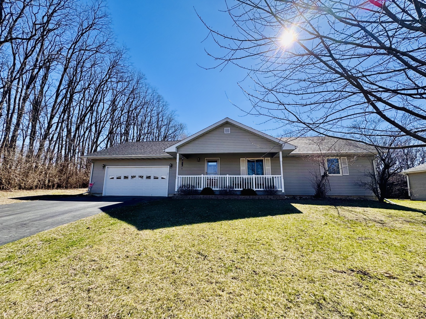 a front view of a house with a yard yard and garage