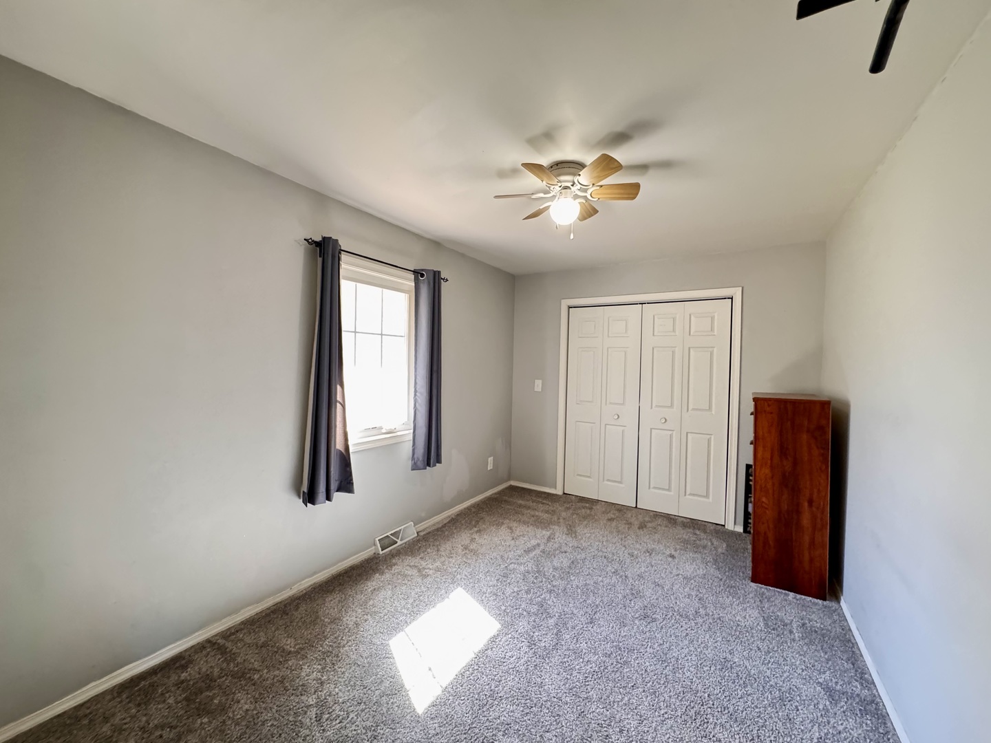 402 Woodside Place Dixon, IL 61021 - Photo 9 of 17 an empty room with windows and fan