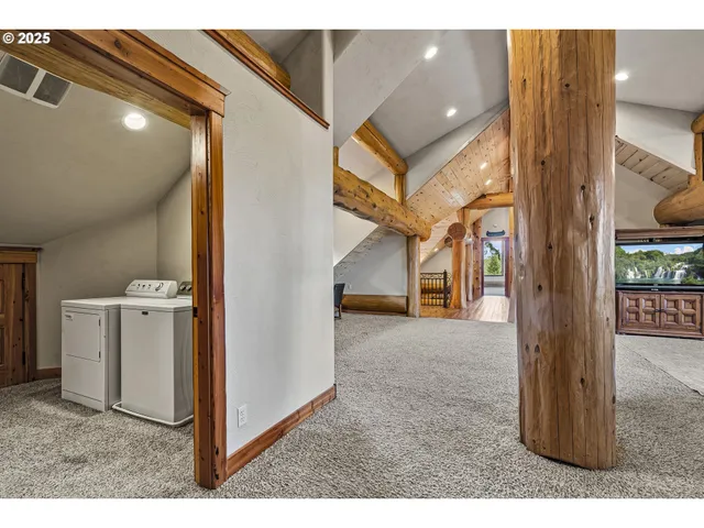 a view of a hallway with a white cabinet and door