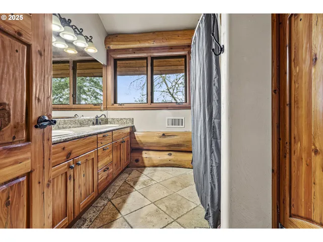 a bathroom with a sink a mirror and a bathtub next to a window