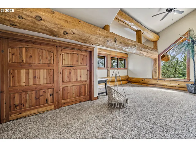a living room with furniture pool table and windows