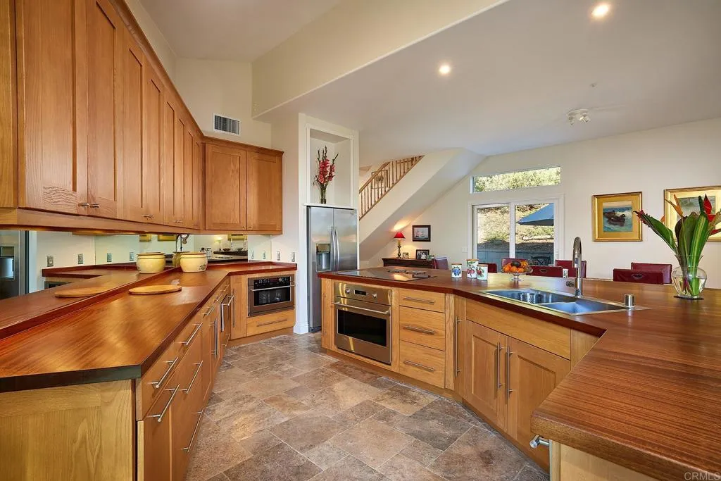 4613 Sun Valley Road Del Mar, CA 92014 - Photo 12 of 55 a kitchen with stainless steel appliances granite countertop sink stove top oven and cabinets