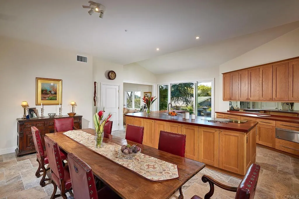 4613 Sun Valley Road Del Mar, CA 92014 - Photo 13 of 55 a dining hall with stainless steel appliances granite countertop a dining table and chairs with wooden floor