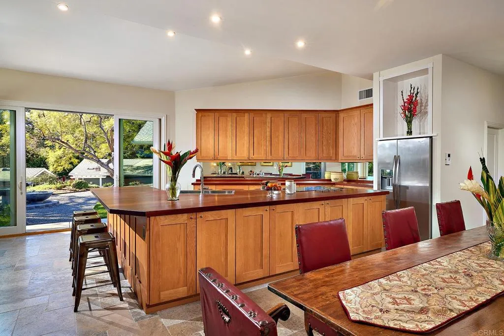 4613 Sun Valley Road Del Mar, CA 92014 - Photo 14 of 55 a kitchen with stainless steel appliances granite countertop a refrigerator a sink dishwasher and wooden cabinets with wooden floor