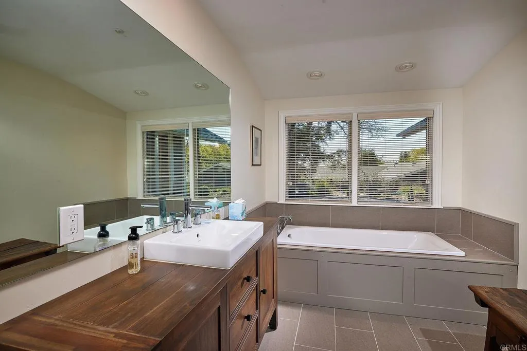 4613 Sun Valley Road Del Mar, CA 92014 - Photo 20 of 55 a spacious bathroom with a bathtub and a sink