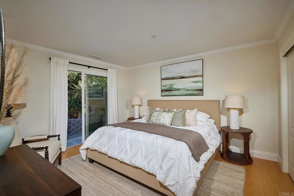 4613 Sun Valley Road Del Mar, CA 92014 - Photo 23 of 55 a bed sitting in a bedroom next to a window