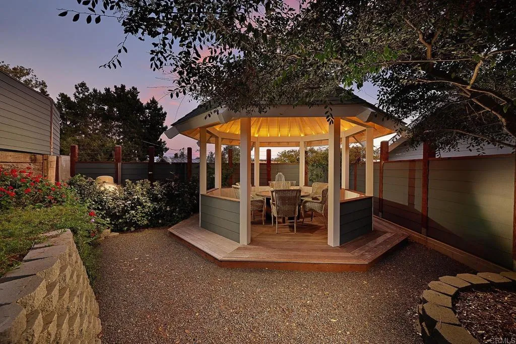 4613 Sun Valley Road Del Mar, CA 92014 - Photo 29 of 55 a view of a patio with table and chairs potted plants and large tree