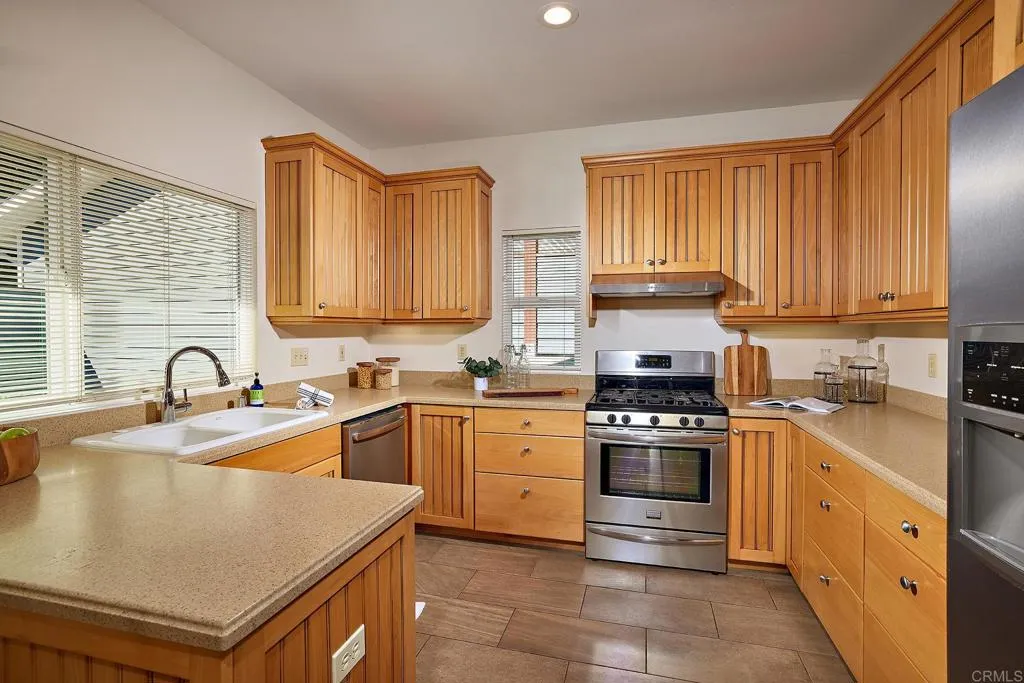 4613 Sun Valley Road Del Mar, CA 92014 - Photo 46 of 55 a kitchen with stainless steel appliances granite countertop a stove sink and cabinets