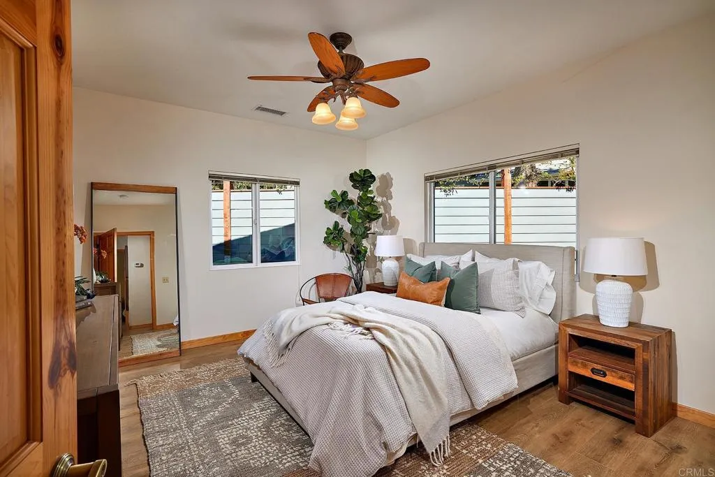 4613 Sun Valley Road Del Mar, CA 92014 - Photo 48 of 55 a bedroom with a bed and a chandelier