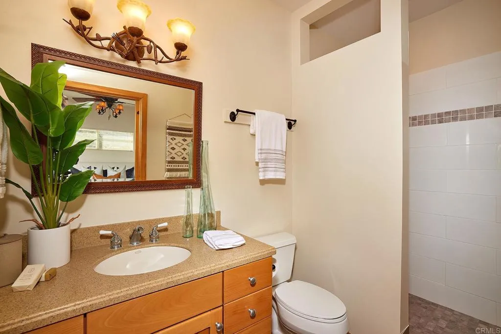 4613 Sun Valley Road Del Mar, CA 92014 - Photo 49 of 55 a bathroom with a granite countertop sink vanity mirror and toilet