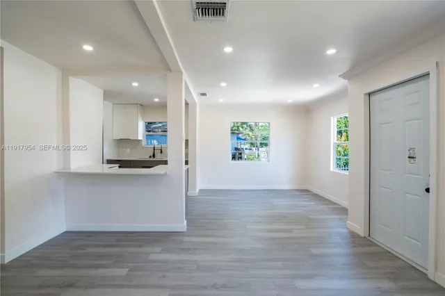 a view of kitchen with wooden floor and window