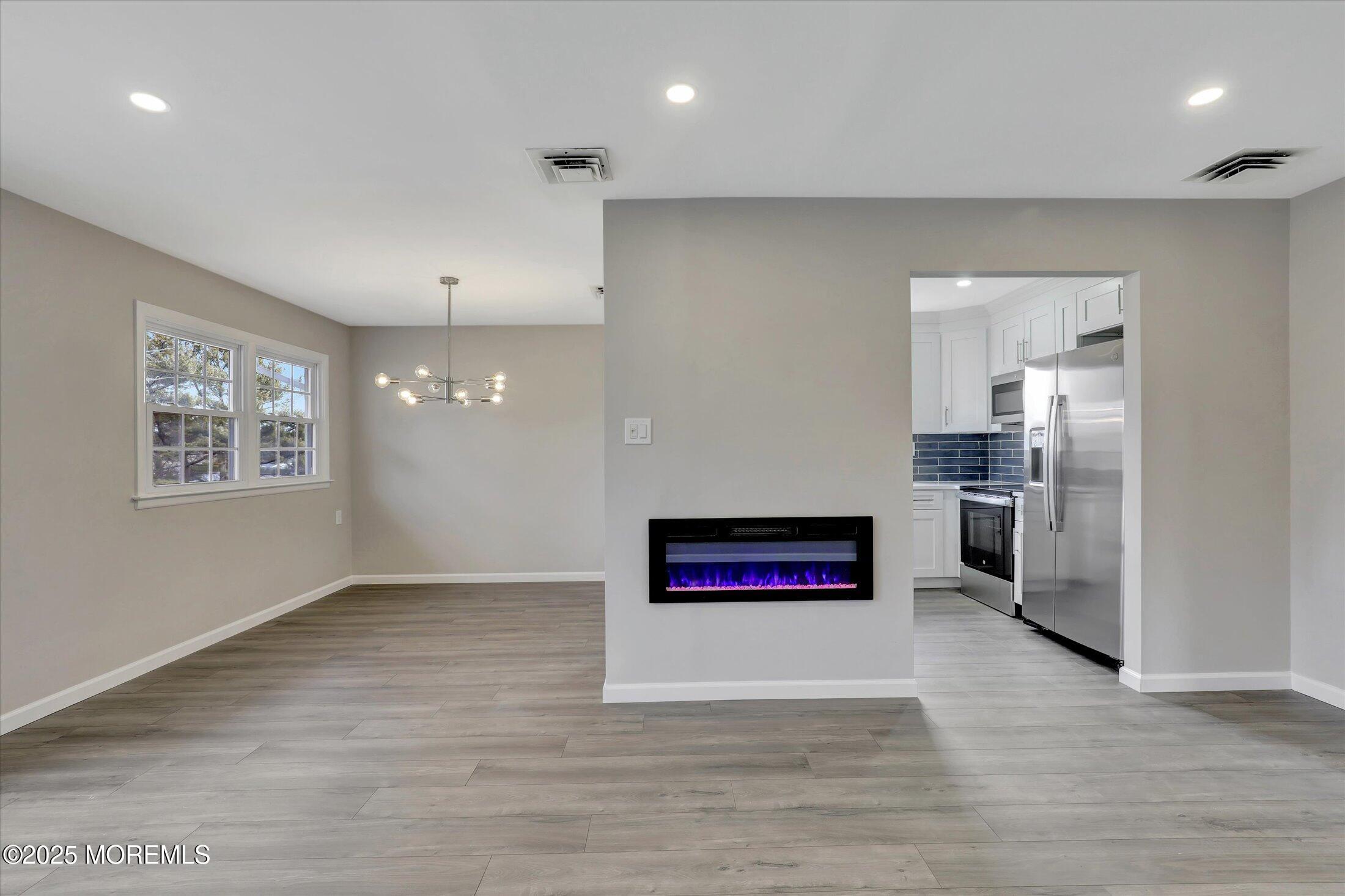 35 Patmore Road Brick, NJ 08724 - Photo 11 of 65 an empty room with kitchen view and windows
