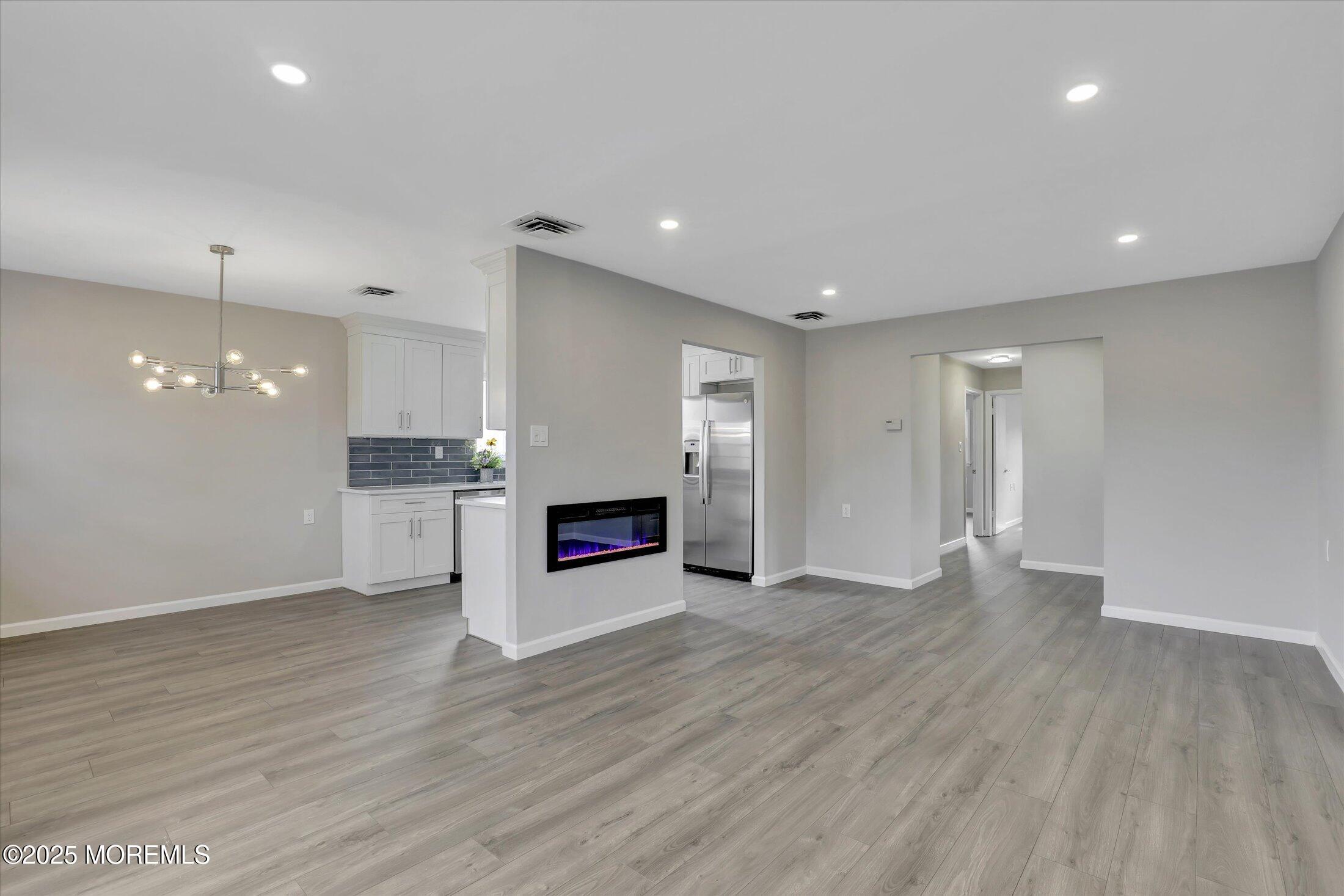 35 Patmore Road Brick, NJ 08724 - Photo 13 of 65 an empty room with wooden floor fireplace and windows
