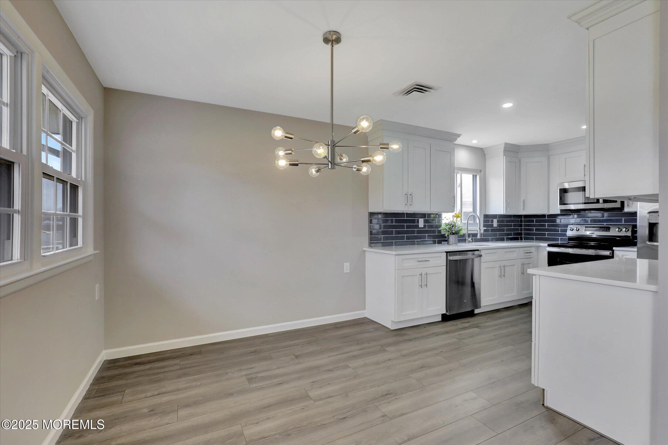 35 Patmore Road Brick, NJ 08724 - Photo 16 of 65 a kitchen with a refrigerator and white cabinets