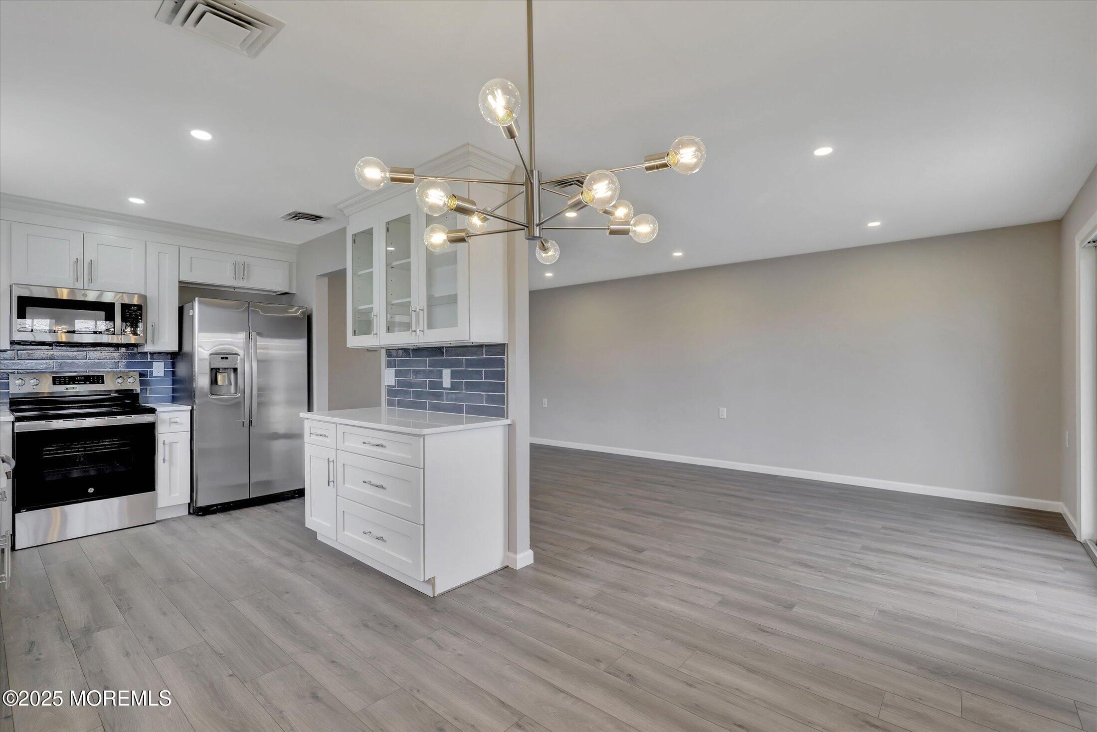 35 Patmore Road Brick, NJ 08724 - Photo 18 of 65 a kitchen with stainless steel appliances a refrigerator sink and stove
