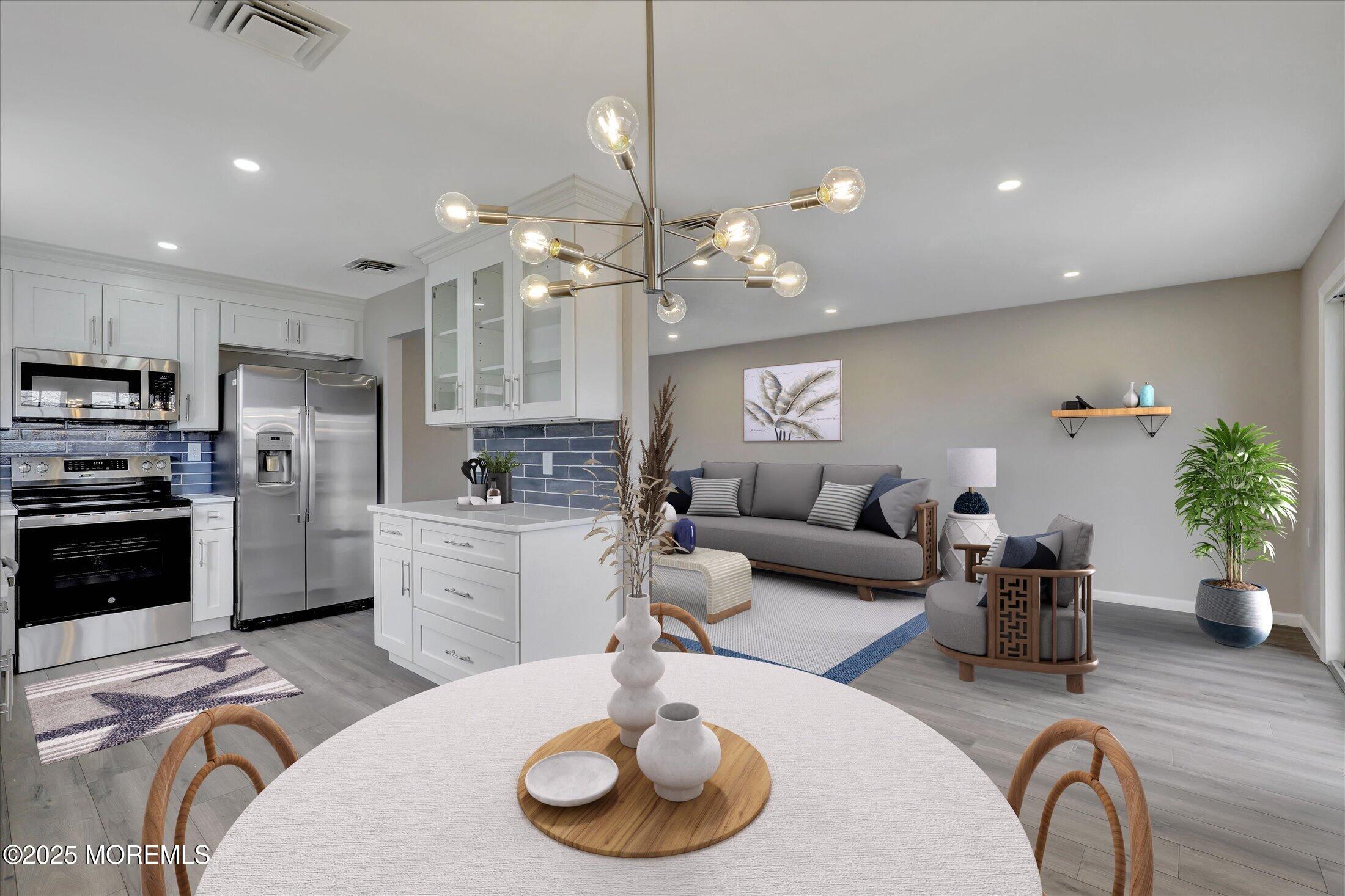 35 Patmore Road Brick, NJ 08724 - Photo 19 of 65 a kitchen with stainless steel appliances a dining table a stove a refrigerator cabinets and living room view