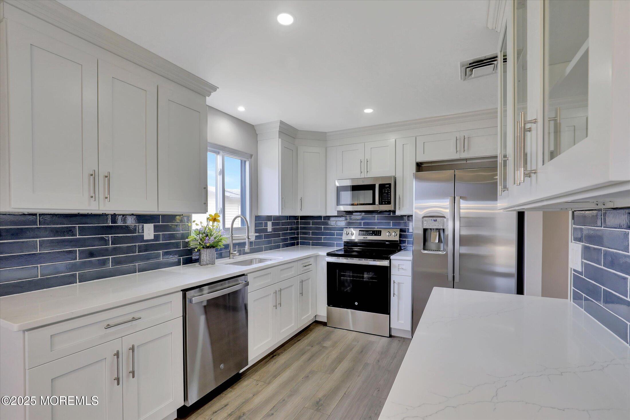 35 Patmore Road Brick, NJ 08724 - Photo 20 of 65 a kitchen with granite countertop a sink stainless steel appliances and cabinets