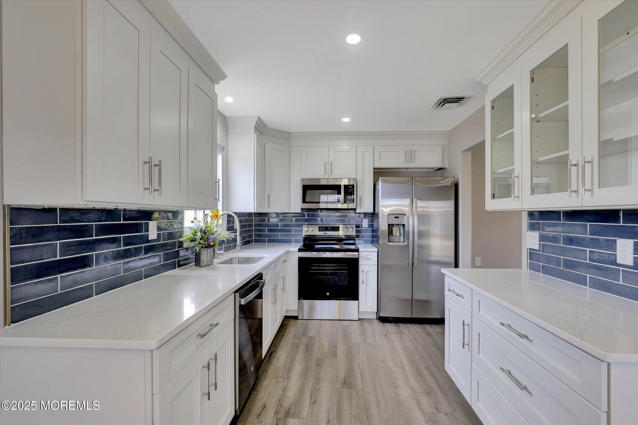 35 Patmore Road Brick, NJ 08724 - Photo 21 of 65 a kitchen with refrigerator a stove top oven and cabinets