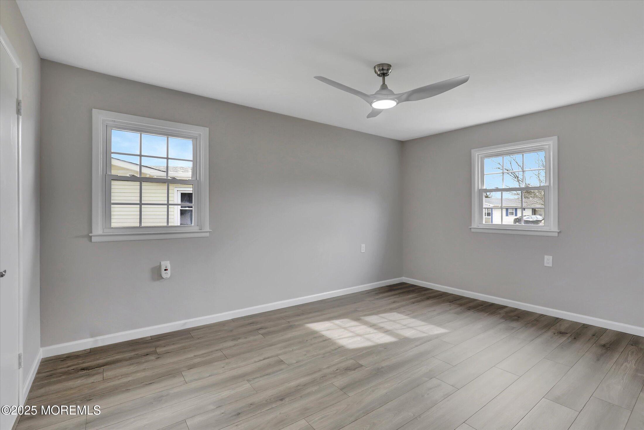 35 Patmore Road Brick, NJ 08724 - Photo 26 of 65 a view of empty room with wooden floor and fan